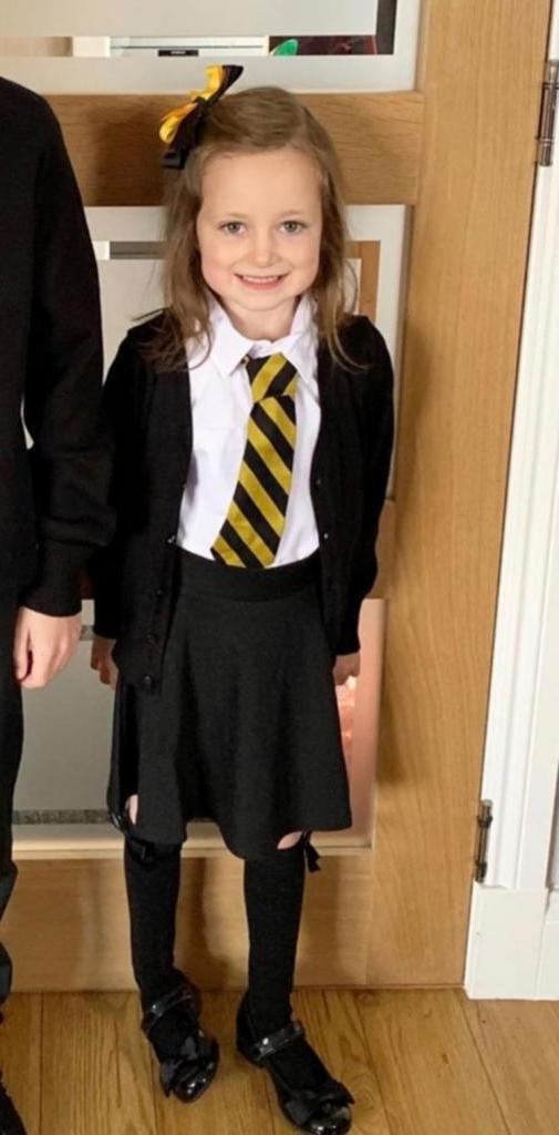 Веселая фотография показывает, что первый день в школе сказался на маленькой девочке